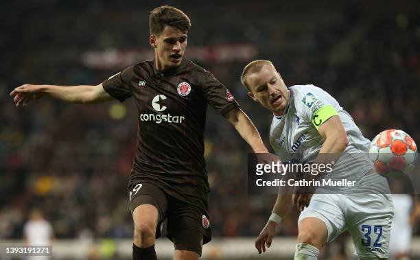 Luca-Milan Zander of FC St. Pauli and Fabian Holland of SV Darmstadt 98 battle for the ball during the Second Bundesliga match between FC St. Pauli...