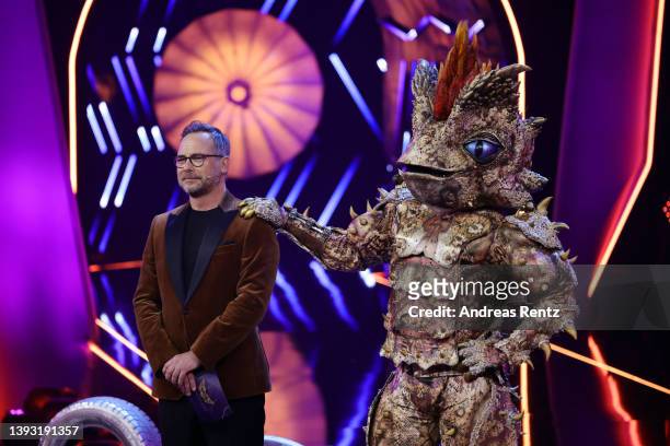 Der Dornteufel" talks to Host Matthias Opdenhoevel and the guessing team after their performance during the finals of the 6th season of "The Masked...