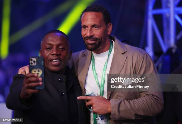 Boxing trainer Tunde Ajayi poses for a photo with former professional footballer Rio Ferdinand during the Commonwealth, British and IBF European...