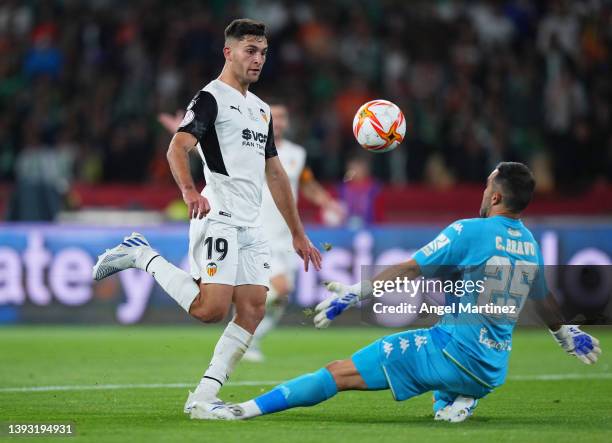 Hugo Duro of Valencia CF scores their team's first goal past Claudio Bravo of Real Betis during the Copa del Rey final match between Real Betis and...