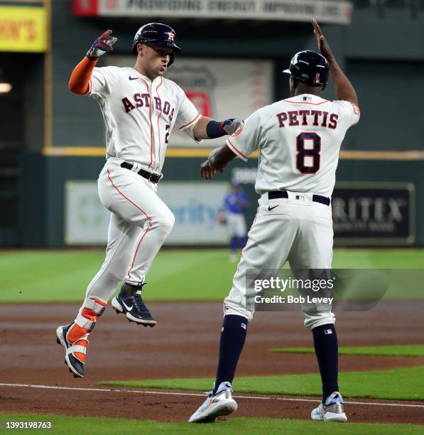 Alex Bregman of the Houston Astros receives a high five from Gary Pettis after hitting a two run home run in the first inning against the Toronto...