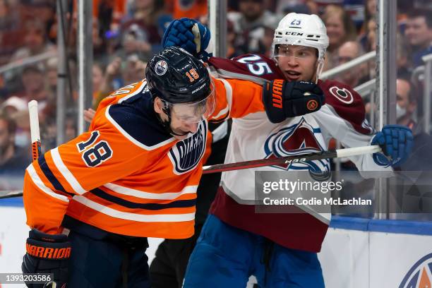 Zach Hyman of the Edmonton Oilers battles against Logan O'Connor of the Colorado Avalanche during the third period at Rogers Place on April 22, 2022...