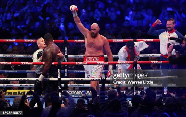 Tyson Fury and their coaching team SugarHill Steward and Andy Lee celebrate victory as referee Mark Lyson checks on Dillian Whyte after the WBC World...
