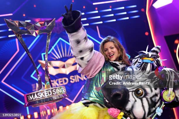 Winner Ella Endlich aka "Das Zebra" poses with her trophy after the finals of the 6th season of "The Masked Singer" at MMC Studios on April 23, 2022...