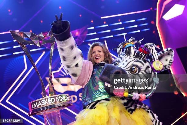 Winner Ella Endlich aka "Das Zebra" poses with her trophy after the finals of the 6th season of "The Masked Singer" at MMC Studios on April 23, 2022...