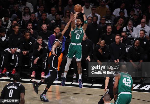 Jayson Tatum of the Boston Celtics shoots against Kevin Durant of the Brooklyn Nets during Game Three of the Eastern Conference First Round NBA...