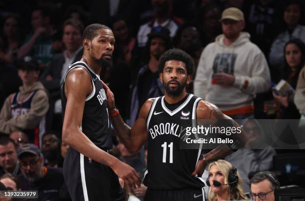Kevin Durant and Kyrie Irving of the Brooklyn Nets look on in the final seconds of their 109-103 loss against the Boston Celtics during Game Three of...