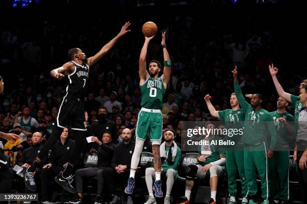 Jayson Tatum of the Boston Celtics hits a three pointer against Kevin Durant of the Brooklyn Nets during Game Three of the Eastern Conference First...