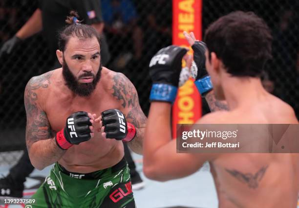Clay Guida battles Claudio Puelles of Peru in a lightweight fight during the UFC Fight Night event at UFC APEX on April 23, 2022 in Las Vegas, Nevada.