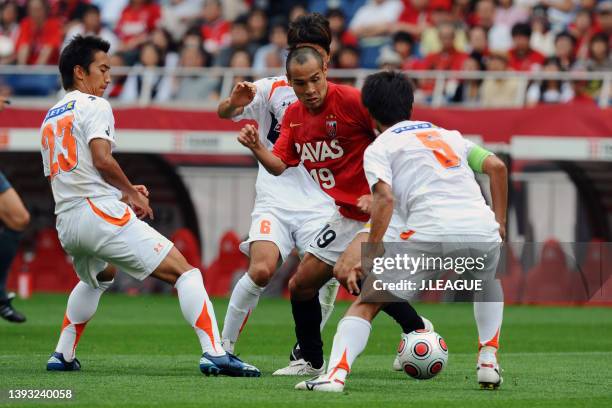 Naohiro Takahara of Urawa Red Diamonds competes for the ball against Omiya Ardija defense during the J.League Yamazaki Nabisco Cup Group A match...