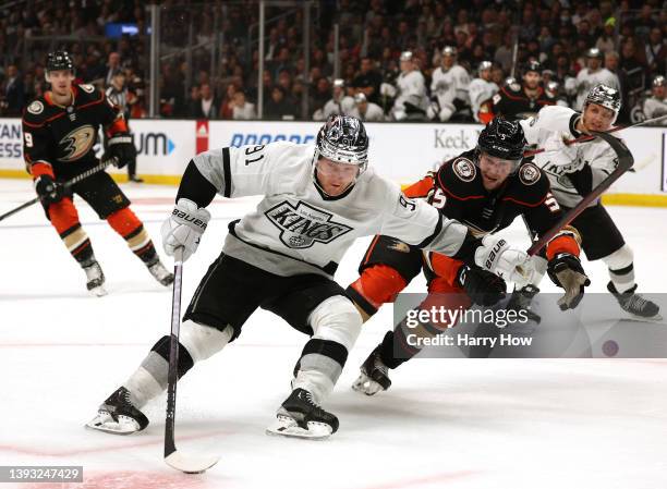Carl Grundstrom of the Los Angeles Kings fends off Urho Vaakanainen of the Anaheim Ducks as he turns to the net during the second period at...