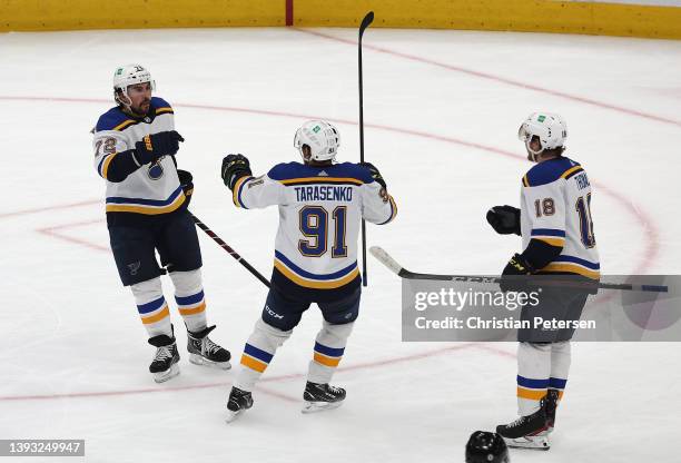 Justin Faulk of the St. Louis Blues celebrates with Vladimir Tarasenko and Robert Thomas after scoring the game winning goal against the Arizona...