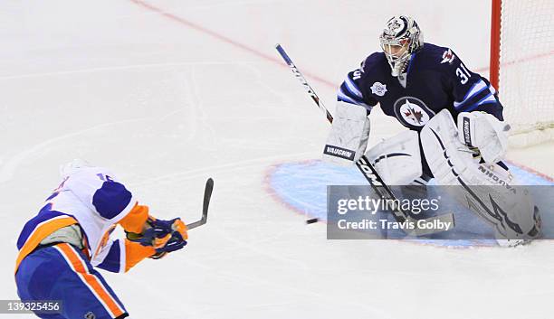 Marty Reasoner of the New York Islanders takes a shot on goaltender Ondrej Pavelec of the Winnipeg Jets during second period action at the MTS Centre...