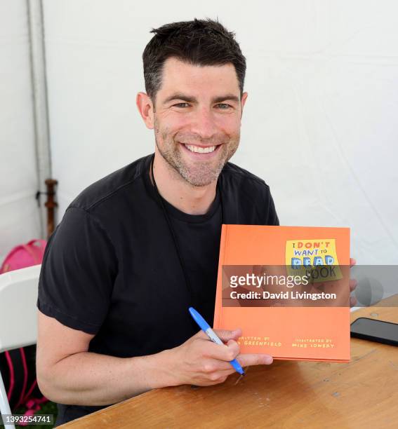 Max Greenfield signs copies of his book "I Don't Want to Read This Book" at the Los Angeles Times Festival of Books at the University of Southern...