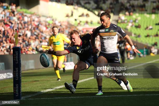 Sam Gilbert of the Highlanders reaches to score a try during the round 10 Super Rugby Pacific match between the Highlanders and the ACT Brumbies at...