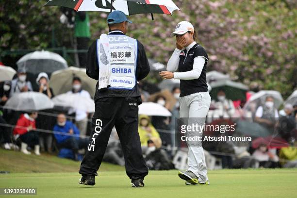 Sayaka Takahashi of Japan shows emotion as she is congratulated by her caddie after winning the tournament on the 18th green during the final round...