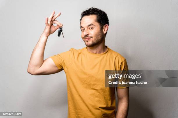 man with beard proudly showing his new car keys in front of camera. . - honors show stock pictures, royalty-free photos & images