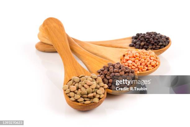 various lentils in wooden spoons isolated on white background. collection - famiglia delle leguminose foto e immagini stock