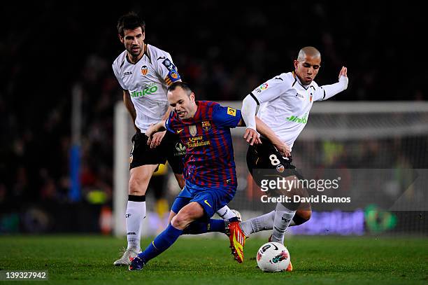 Andres Iniesta of FC Barcelona duels for the ball with David Albelda of Valencia CF and Sofiane Feghouli of Valencia CF during the La Liga match...