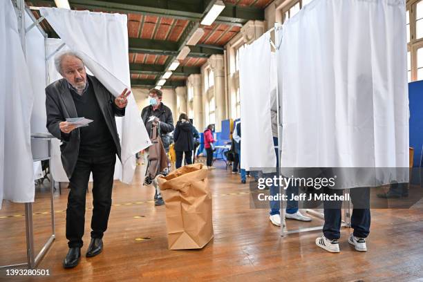 Members of the public cast their votes at Lycee Voltaire polling station during the final round of the presidential elections on April 24, 2022 in...