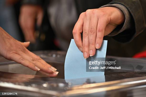 Members of the public cast their votes at Lycee Voltaire polling station during the final round of the presidential elections on April 24, 2022 in...