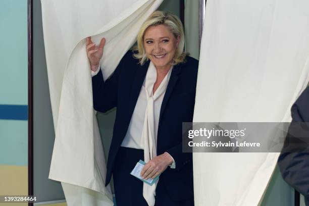 French far-right National Rally candidate Marine Le Pen leaves a polling booth to cast her ballot for 2nd round of presidential election on April 24,...
