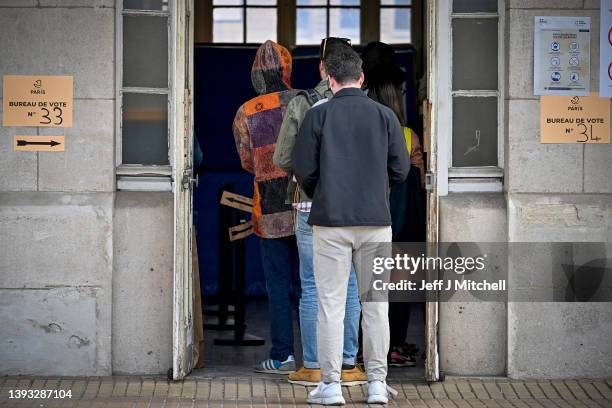 Members of the public cast their votes at Lycee Voltaire polling station during the final round of the presidential elections on April 24, 2022 in...