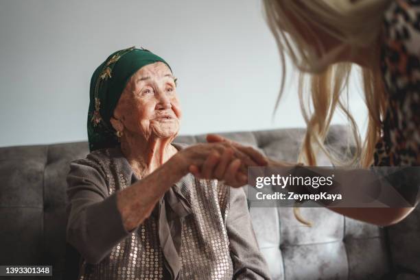 kissing grandma's hand - kyssa på handen bildbanksfoton och bilder