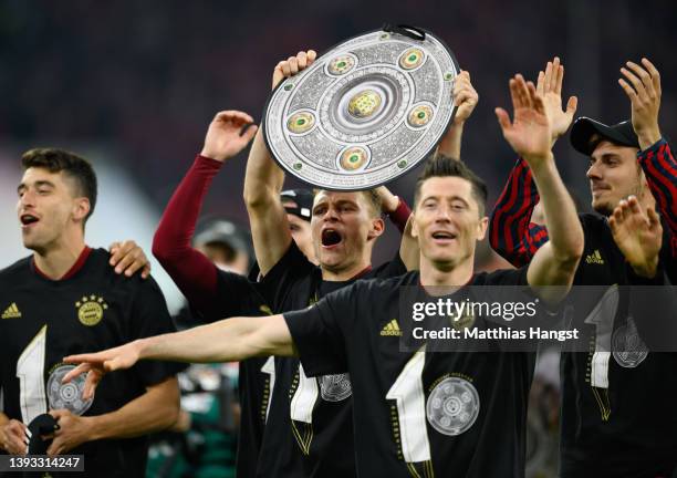 Joshua Kimmich of FC Bayern Muenchen celebrates after their sides victory which wins FC Bayern Muenchen the Bundesliga title during the Bundesliga...