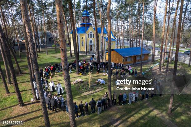 As seen from an aerial view, priests perform blessings while celebrating Orthodox Easter outside a war-damaged church on April 24, 2022 in Irpin,...