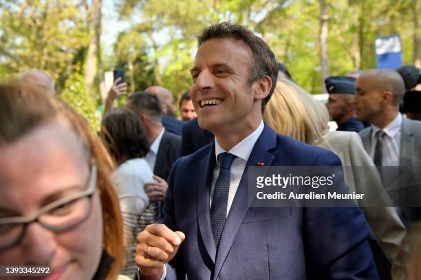 Emmanuel Macron salutes voters as he leaves after voting on April 24, 2022 in Le Touquet-Paris-Plage, France. Emmanuel Macron and Marine Le Pen were...