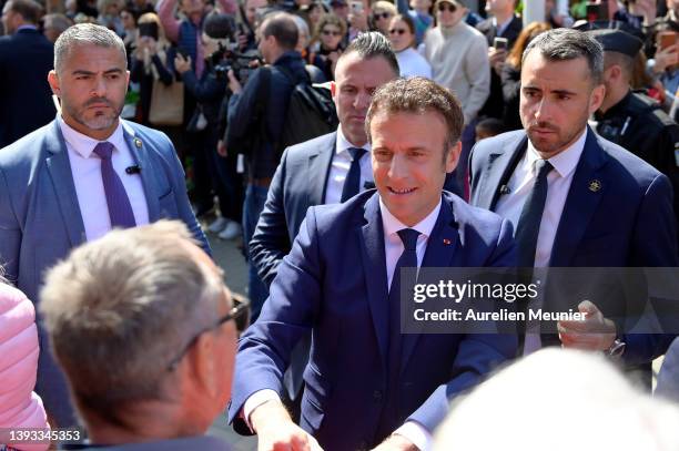 Emmanuel Macron salutes voters as he leaves his house to go vote on April 24, 2022 in Le Touquet-Paris-Plage, France. Emmanuel Macron and Marine Le...