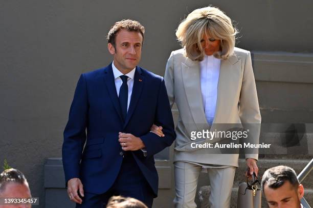 Emmanuel Macron salutes voters as he leaves his house with Brigitte Macron to go vote on April 24, 2022 in Le Touquet-Paris-Plage, France. Emmanuel...