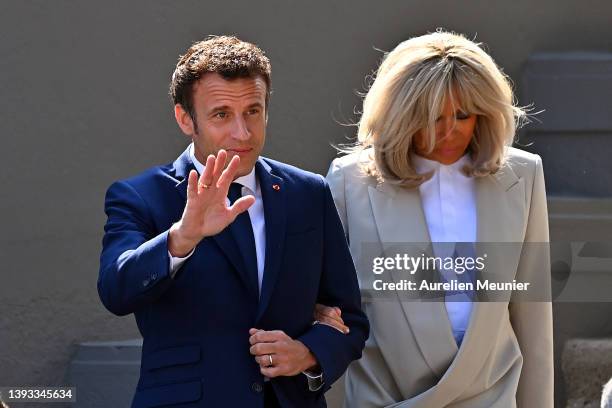 Emmanuel Macron salutes voters as he leaves his house with Brigitte Macron to go vote on April 24, 2022 in Le Touquet-Paris-Plage, France. Emmanuel...