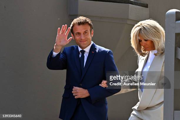 Emmanuel Macron salutes voters as he leaves his house with Brigitte Macron to go vote on April 24, 2022 in Le Touquet-Paris-Plage, France. Emmanuel...