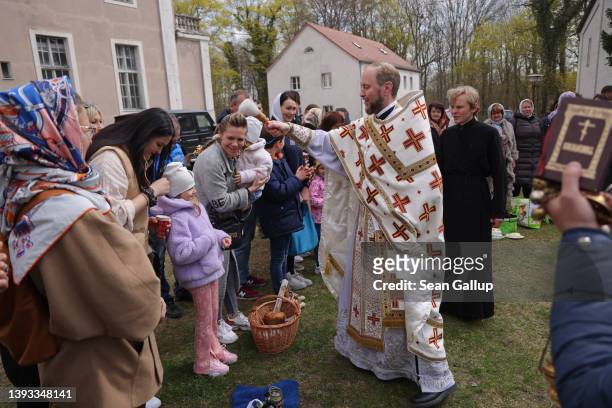 Abbot Daniil Irbits, Prior of the Russian Orthodox St. George Monastery, blesses local Russians and recently arrived Ukrainian refugees at the...