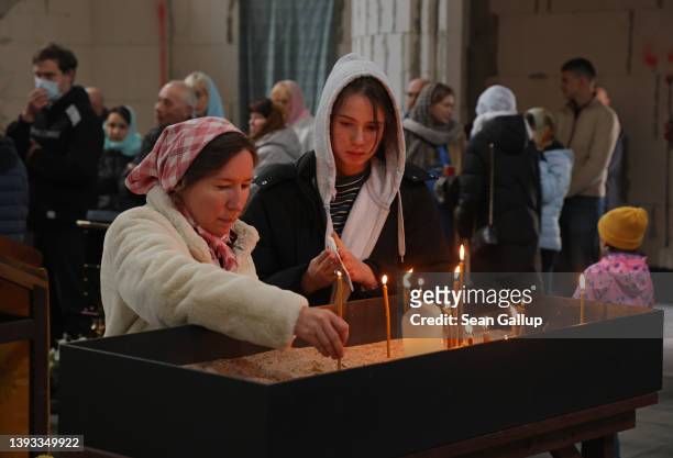 People, among them local Russians and recently arrived Ukrainian refugees, celebrate Orthodox Easter Sunday mass at the Russian Orthodox St. George...