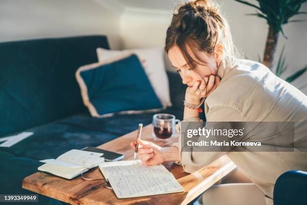 woman working online on laptop at home. - writer desk stock pictures, royalty-free photos & images