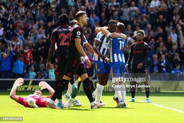 Danny Welbeck of Brighton & Hove Albion celebrates Leandro Trossard after scoring their team's first goal during the Premier League match between...