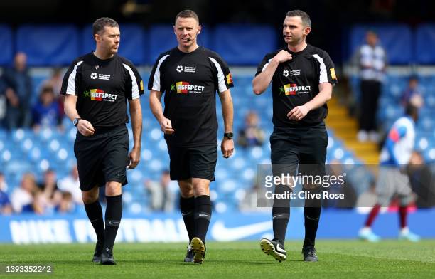Referee Michael Oliver warms up with match assistants whilst wearing a 'Don't X the line campaign' t-shirt prior to the Premier League match between...