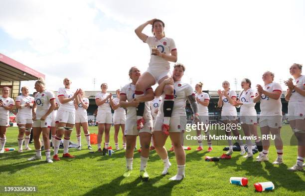 Marlie Packer and Hannah Botterman lift Emily Scarratt of England, as she celebrates with teammates after receiving her 100th Cap after the final...