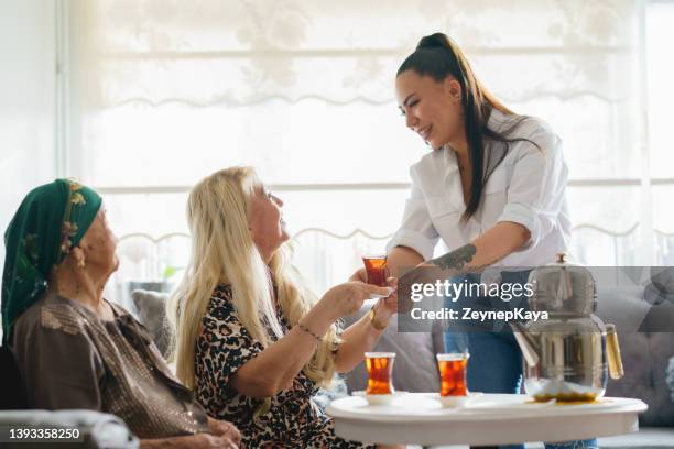 96 years old senior woman, tea time with her family - turkish culture stock pictures, royalty-free photos & images