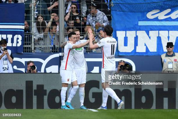 Andre Hahn of FC Augsburg celebrates scoring their side's first goal with teammates during the Bundesliga match between VfL Bochum and FC Augsburg at...