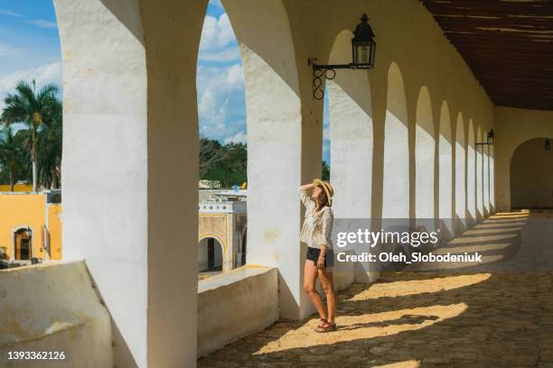 woman walking  among columns in izamal town in mexico - mérida mexiko bildbanksfoton och bilder