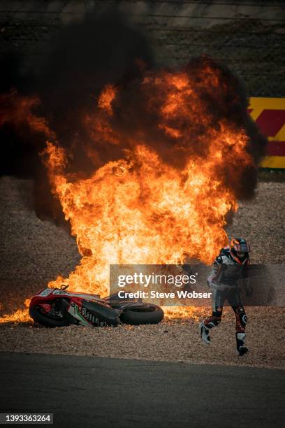 Moto2 rider Zonta Van Den Goorbergh of Netherlands and RW Racing GP runs away from the fire after a mass crash during the Moto2 race due to wet track...