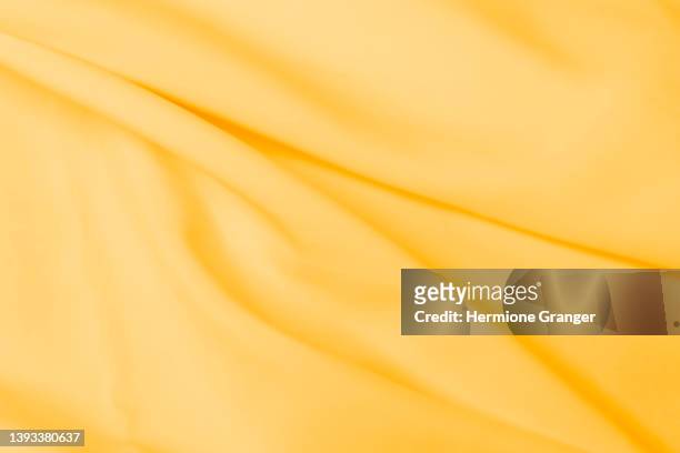 background image of yellow cloth - yellow shirt stock pictures, royalty-free photos & images