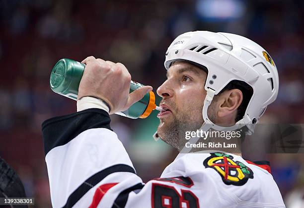 John Scott of the Chicago Blackhawks takes a drink of water during the team warmup prior to NHL action on January 31, 2012 against the Vancouver...