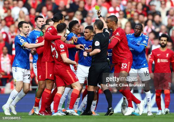 Sadio Mane of Liverpool is shown a yellow card by referee Stuart Attwell during the Premier League match between Liverpool and Everton at Anfield on...