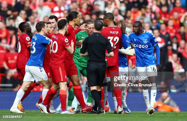 Jordan Pickford of Everton clashes with Joel Matip of Liverpool during the Premier League match between Liverpool and Everton at Anfield on April 24,...