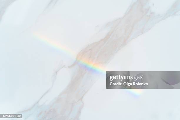 gray and white shiny marble rock texture background with rainbow light reflection - marble rock foto e immagini stock